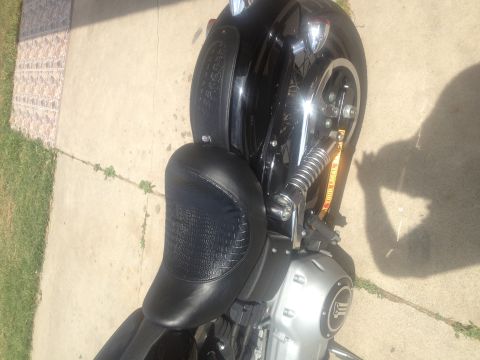 1995 Ford Bronco - Close-up view of a motorcycle's seat and engine area, showing a visible logo.
