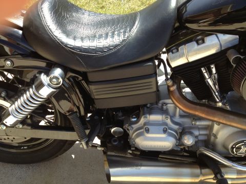 1995 Ford Bronco - Close-up view of a black motorcycle's engine and seat, showing intricate details of its construction.