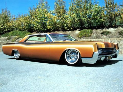 1991 Ford LTD Crown Victoria - A heavily modified coupe with a two-tone paint job and custom wheels sits low to the ground.