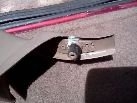 1995 Ford Bronco - Close-up of a vehicle interior trim piece, showing a rubber bumper and mounting bracket.