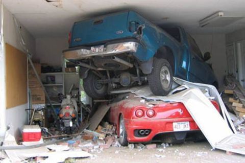 1999 Ford Ranger - A blue 1999 Ford Ranger is on top of a red Ferrari after an apparent accident in a garage.