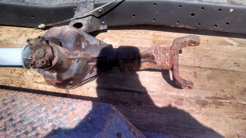 1979 Ford Bronco - A heavily rusted rear axle assembly is shown resting on a wooden surface, likely a trailer or truck bed.
