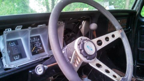 1979 Ford Bronco - Interior view of a 1979 Ford Bronco, focusing on the dashboard and steering wheel.
