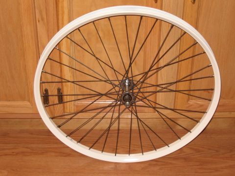 1994 Ford Bronco - A bicycle wheel with a white rim and silver spokes is shown against a wooden background.