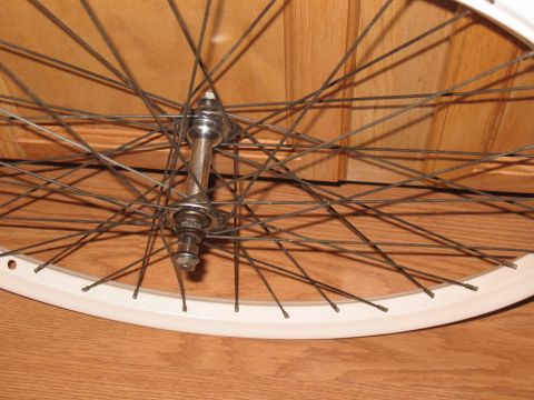 1994 Ford Bronco - A bicycle wheel is shown against a wooden background.