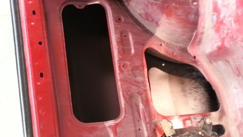 1991 Ford Festiva - Close-up view of a car's interior, revealing structural openings and textured surfaces.
