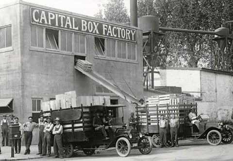 1909 Ford Model T - Workers load wooden crates onto 1909 Ford Model T trucks outside the Capital Box Factory.