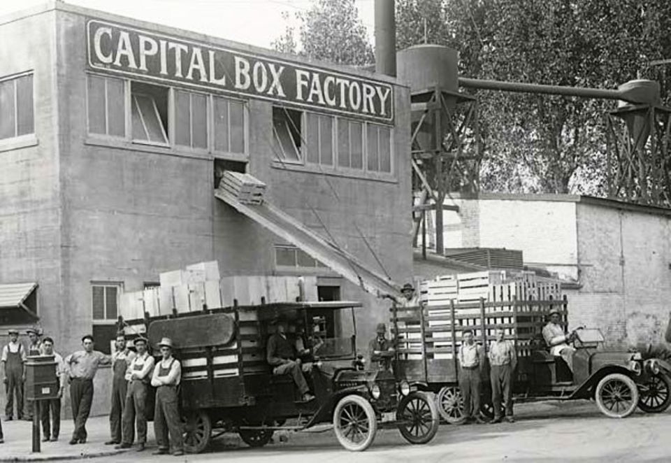 1909 Ford Model T trucks being loaded with wooden crates at Capital Box Factory