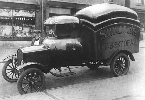 1909 Ford Model T - A 1909 bread loaf truck, branded 'Sillito's The Best of All', parked outside a shop.
