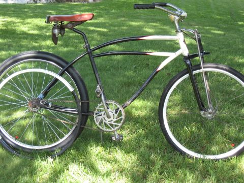 1994 Ford Bronco - This bicycle features a unique frame design with black and white paint accents, a sprung leather seat, and chrome handlebars.