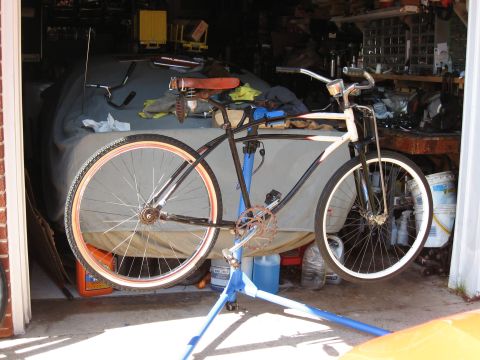 1994 Ford Bronco - A bicycle is shown on a repair stand inside a garage, with its frame painted black and white.