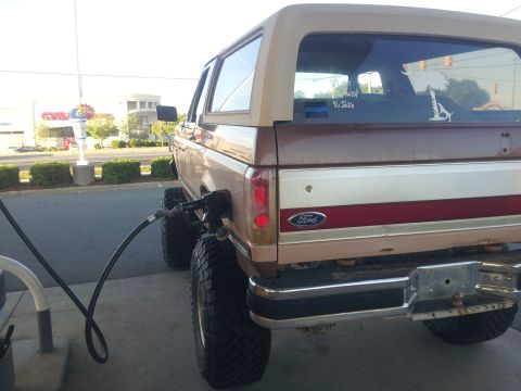 1988 Ford Bronco - A 1988 Ford Bronco is seen refueling at a gas station.