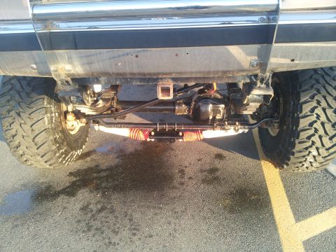 1988 Ford Bronco - Close-up view of the rear axle and suspension system on a modified truck.
