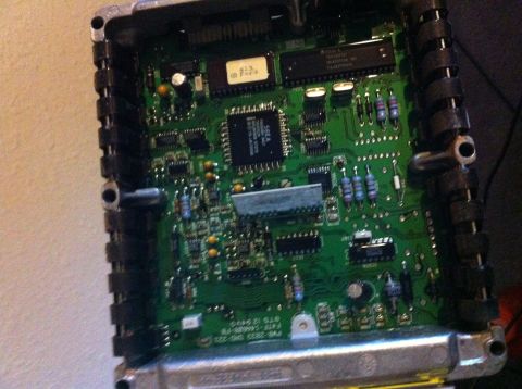 1992 Ford F-150 - An automotive engine computer opened up, showing the green PCB inside its finned aluminum case with a hand-labeled "413 Ford" EPROM sticker…