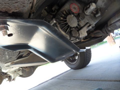 1994 Jeep Cherokee - A low-angle view of a vehicle's undercarriage, revealing mechanical components and a skid plate.