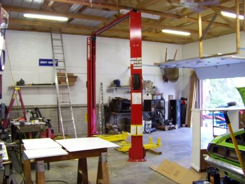 1974 Dodge Challenger - Garage scene a car lift, tools, and a green car partially visible on the right.