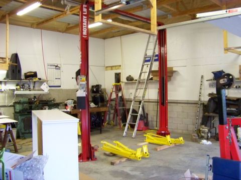 1974 Dodge Challenger - Interior view of a workshop a car lift and various automotive equipment.