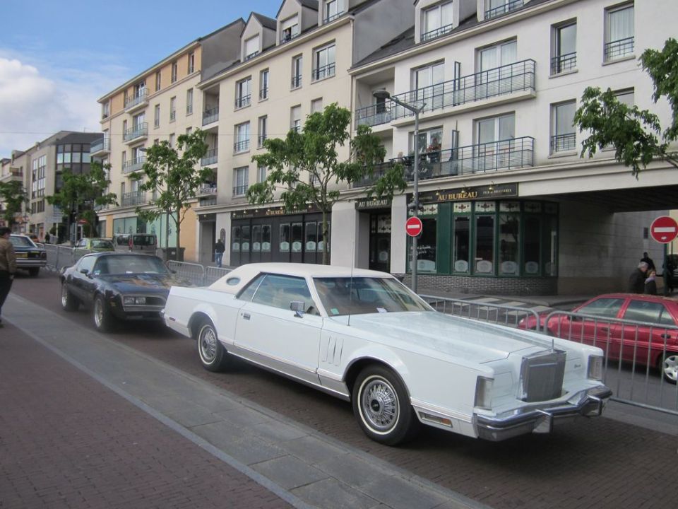 White 1980 Lincoln Continental Mark VI coupe parked on street, front 3/4 view