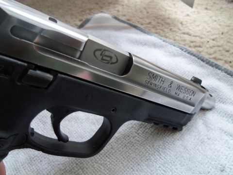 2000 Mercury Grand Marquis - A close-up view of a Smith & Wesson pistol, showing its engraved markings and construction.