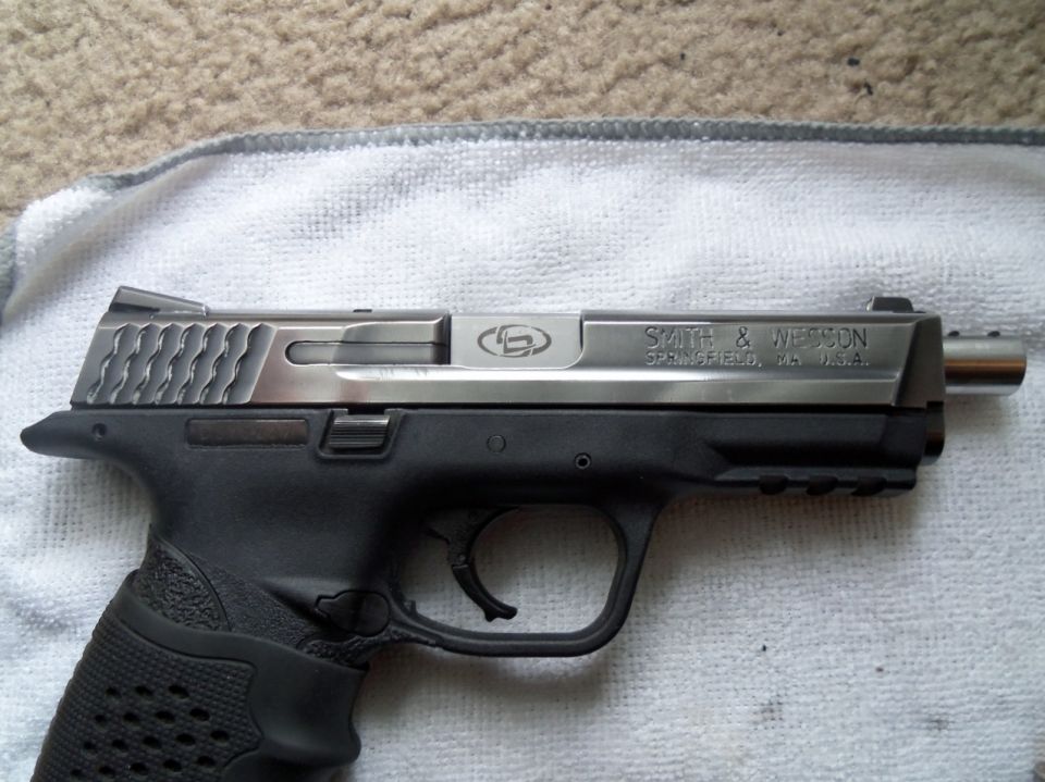 Pistol with stainless steel slide and black polymer frame, Smith & Wesson markings visible
