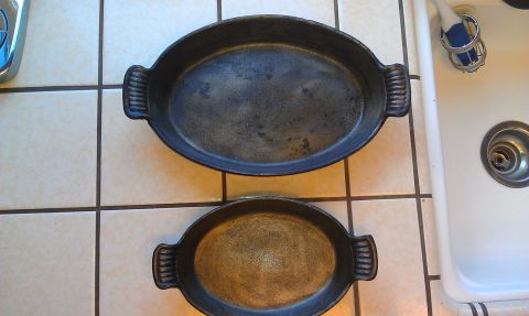 1989 Ford Bronco - Two cast iron baking dishes, one larger than the other, sit on a tiled surface near a kitchen sink.
