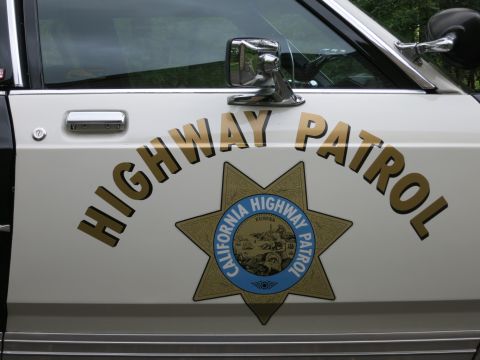 1991 Ford LTD Crown Victoria - Detail of a car door showing Highway Patrol gold lettering and the California Highway Patrol star-and-seal emblem.