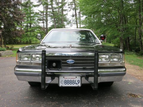 1991 Ford LTD Crown Victoria - Front end of a black-and-white Ford sedan fitted with a black push bumper and a California license plate reading 888849.