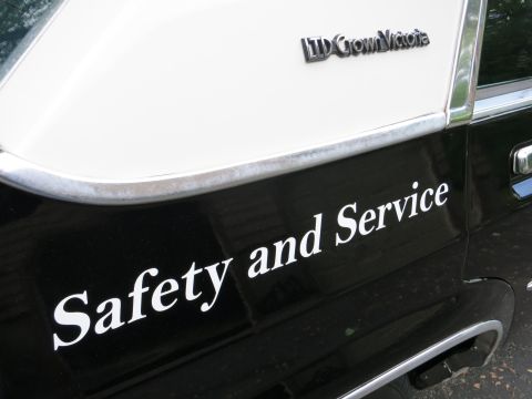 1991 Ford LTD Crown Victoria - Black-and-white car bodywork showing an 'LTD Crown Victoria' badge above white 'Safety and Service' lettering.