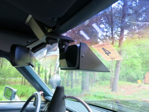 1991 Ford LTD Crown Victoria - black windshield-mounted box, likely radar, inside a car with a paper card showing the number 4 tucked in the glass.
