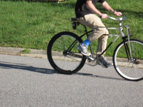 1994 Ford Bronco - A person rides a bicycle on a sunny day.