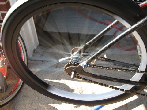 1994 Ford Bronco - Close-up of a bicycle's rear wheel and drivetrain, with motion blur on the spokes.