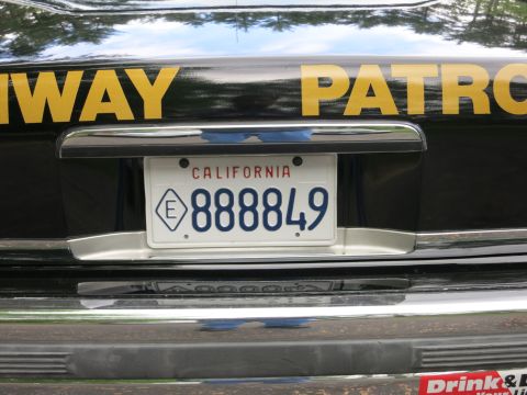 1991 Ford LTD Crown Victoria - California license plate reading 888849 on a black trunk lid beneath gold HIGHWAY PATROL lettering.
