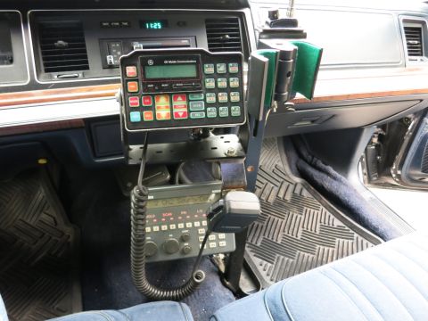 1991 Ford LTD Crown Victoria - Vehicle interior showing a GE Mobile Communications two-way radio and control head mounted on a center console with handset.