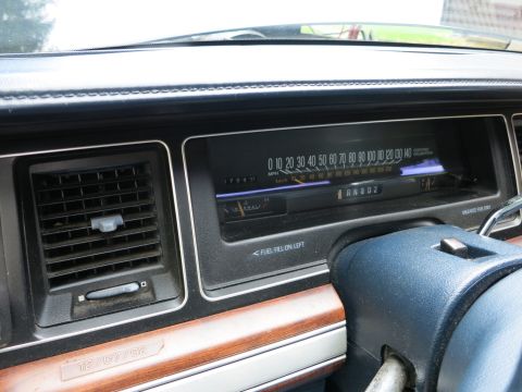 1991 Ford LTD Crown Victoria - Dashboard instrument panel with horizontal speedometer, woodgrain trim, AC vent and a small 12/07/92 date plate.