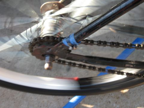 1994 Ford Bronco - The drivetrain of a bicycle is shown in motion, with the chain and spokes blurred.