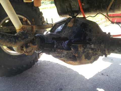 1988 Ford Bronco - Close-up view of the rear axle and suspension of a vehicle.