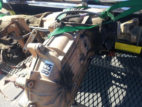 1988 Ford Bronco - A close-up view of a transfer case, possibly for a Ford Bronco, secured with green straps.