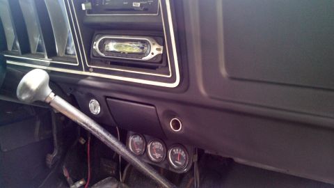 1979 Ford Bronco - The interior of a 1979 Ford Bronco shows the dashboard, floor shifter, and auxiliary gauges.