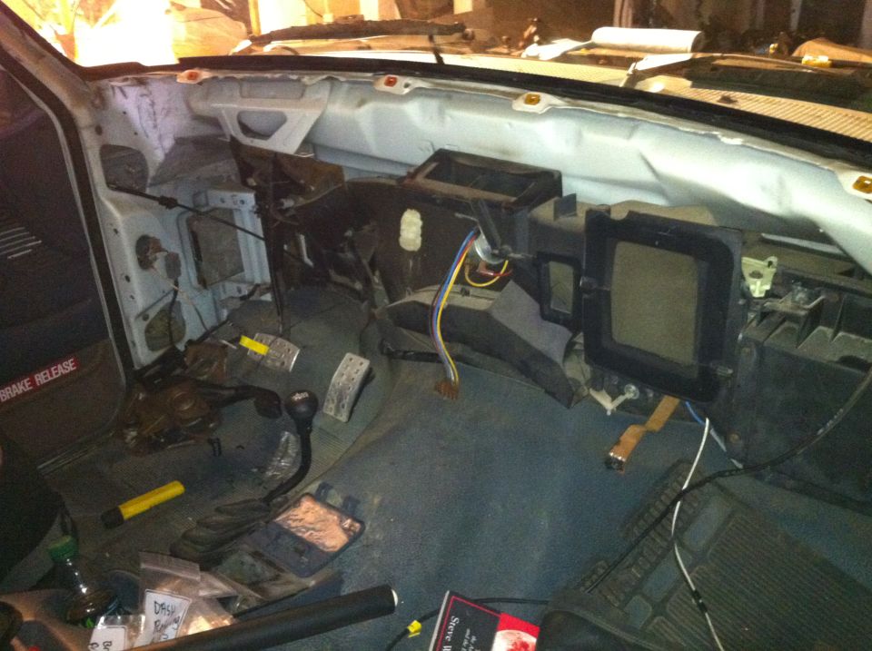 1992 Ford Bronco interior with dashboard removed, showing wiring and HVAC components