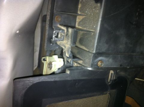 1992 Ford Bronco - This photo shows a close-up of a car's interior, focusing on a plastic component and its mounting hardware.
