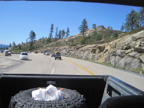 1989 Ford Bronco - Driving on a highway with a view of rocky terrain and other vehicles on a clear day.