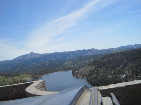1989 Ford Bronco - A scenic view of a lake surrounded by forested mountains under a blue sky with wispy clouds.