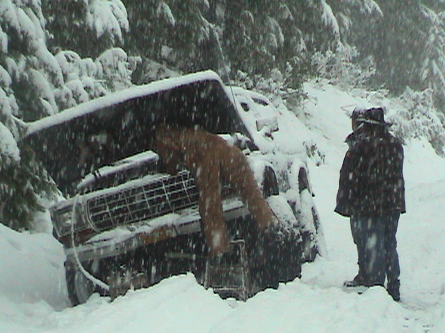 Jim eagerly working on his truck, Ken & Nick assisting.