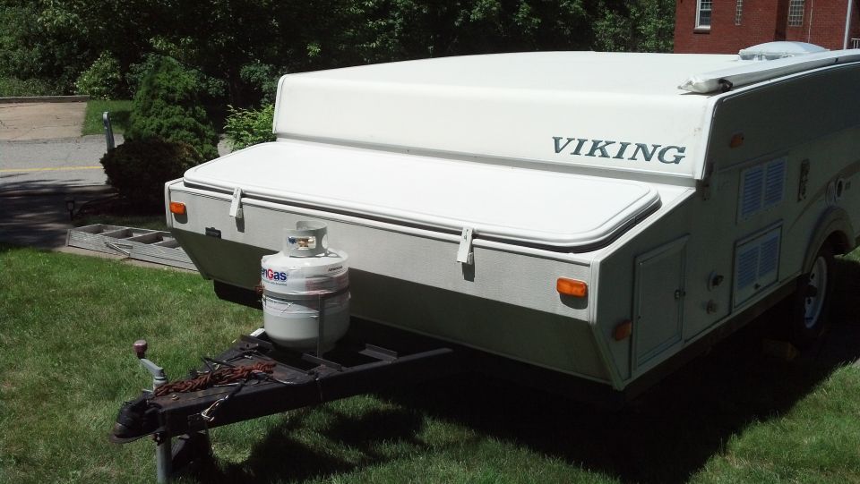 Pop-up camper trailer with 'VIKING' branding on top, propane tank on hitch