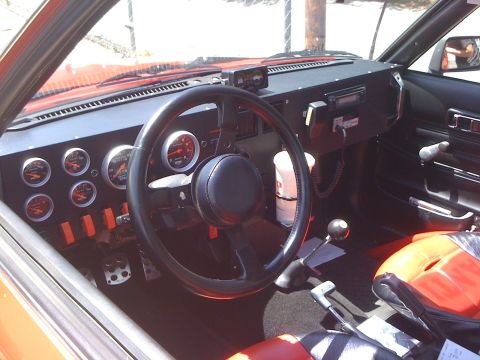 1968 Ford Mustang - Customized interior features numerous gauges and racing seats, suggesting performance modifications.