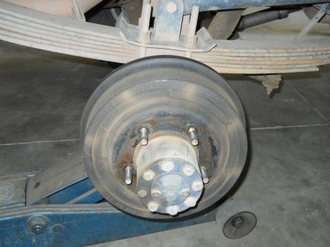 1992 Ford Bronco - Close-up view of a rear drum brake assembly, likely from a truck or SUV, supported by a jack.