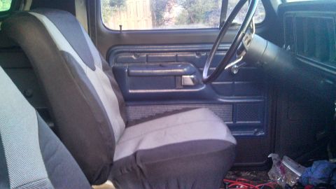 1979 Ford Bronco - The interior of a 1979 Ford Bronco is visible, including the door panel and seats.