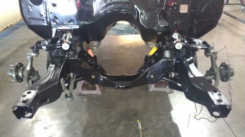 1972 Pontiac Trans Am - Front suspension and frame components of a car undergoing restoration or repair.