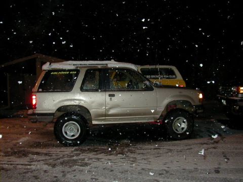 1994 Ford Explorer - A silver 1994 Ford Explorer is parked outside in the snow, with another vehicle visible behind it.