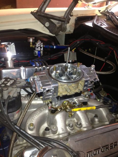 1972 Ford Ranchero - Close-up of a vehicle's engine bay, focusing on the carburetor and ignition system components.